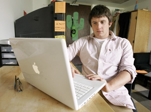 Phil Miatkowski, a sophomore at Lake Forest College, works on his laptop in his dorm room in May. Miatkowski keeps his friends informed about legislation to legalize civil unions in Illinois. 
